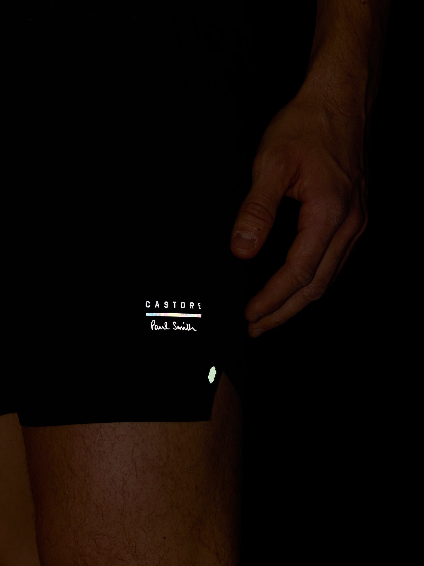 Black shorts with 'Castore' branding on a dark background