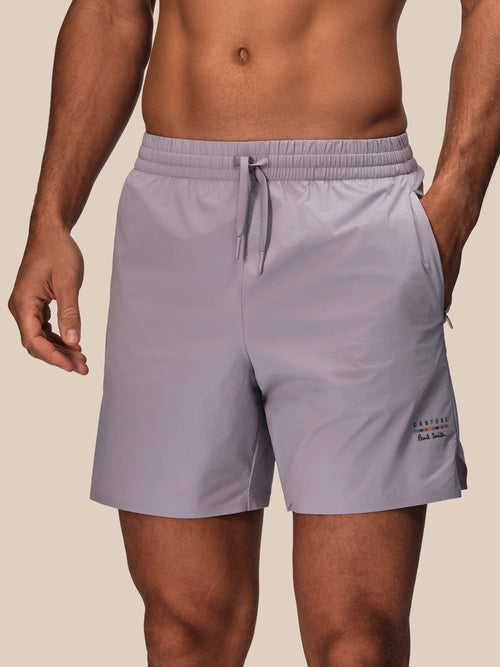 Front view of mauve Castore Paul Smith performance shorts with drawstring waistband and a small leg logo