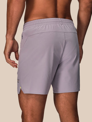 Back view of mauve Castore Paul Smith performance shorts showing elastic waistband and back pocket