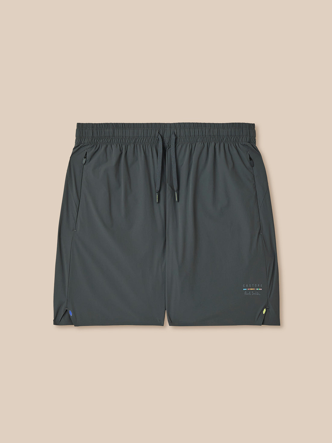 Dark gray shorts with a small logo on a beige background
