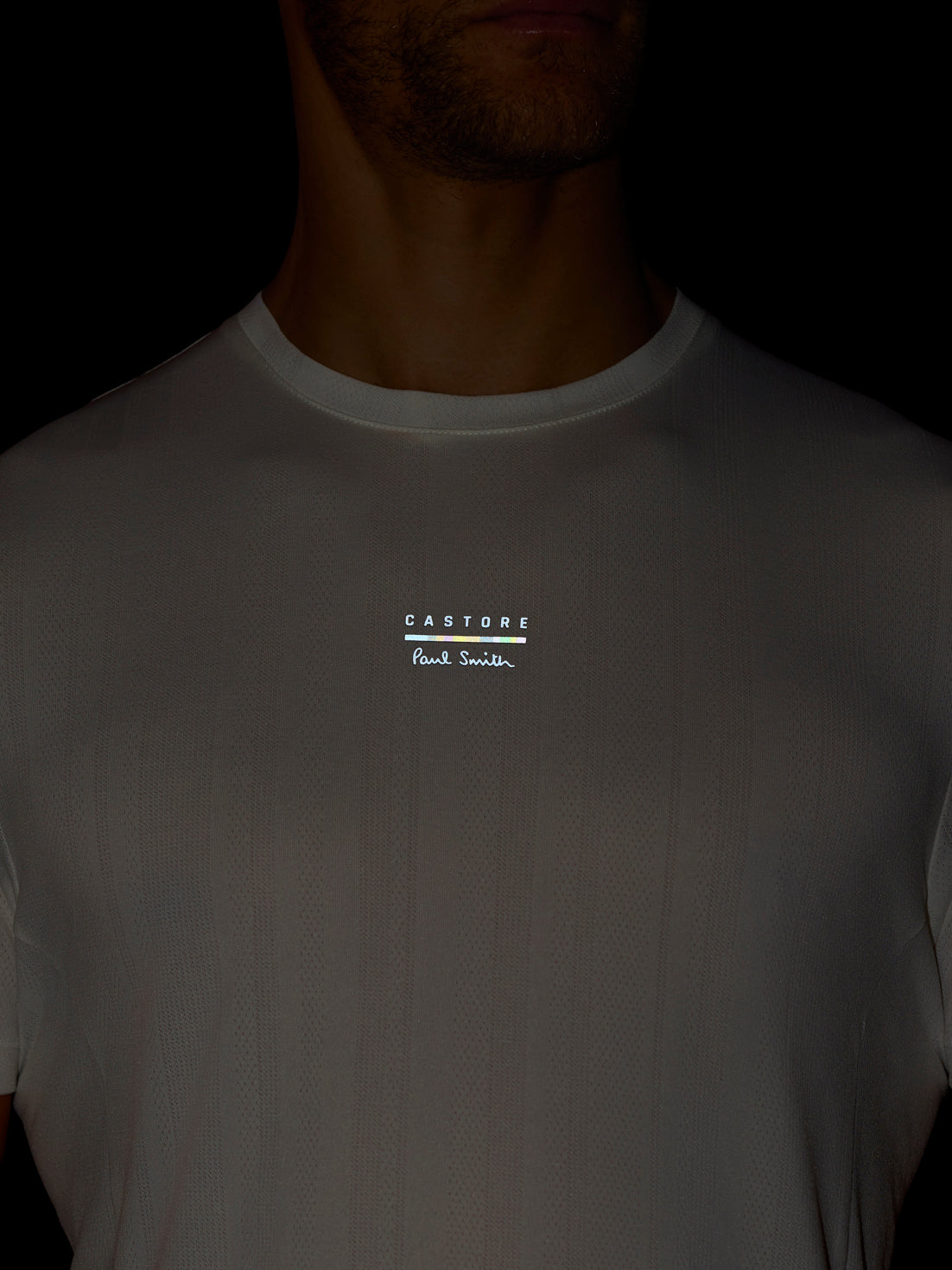 White t-shirt with a logo on a black background