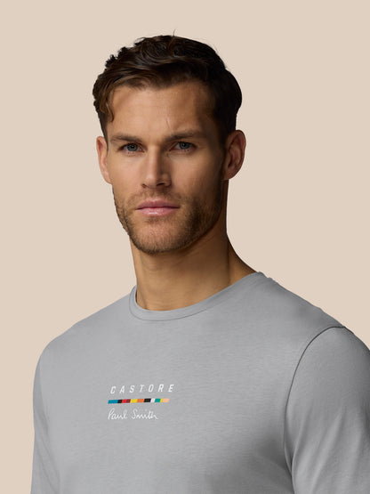 Man wearing a gray t-shirt with 'Castore' branding on a beige background