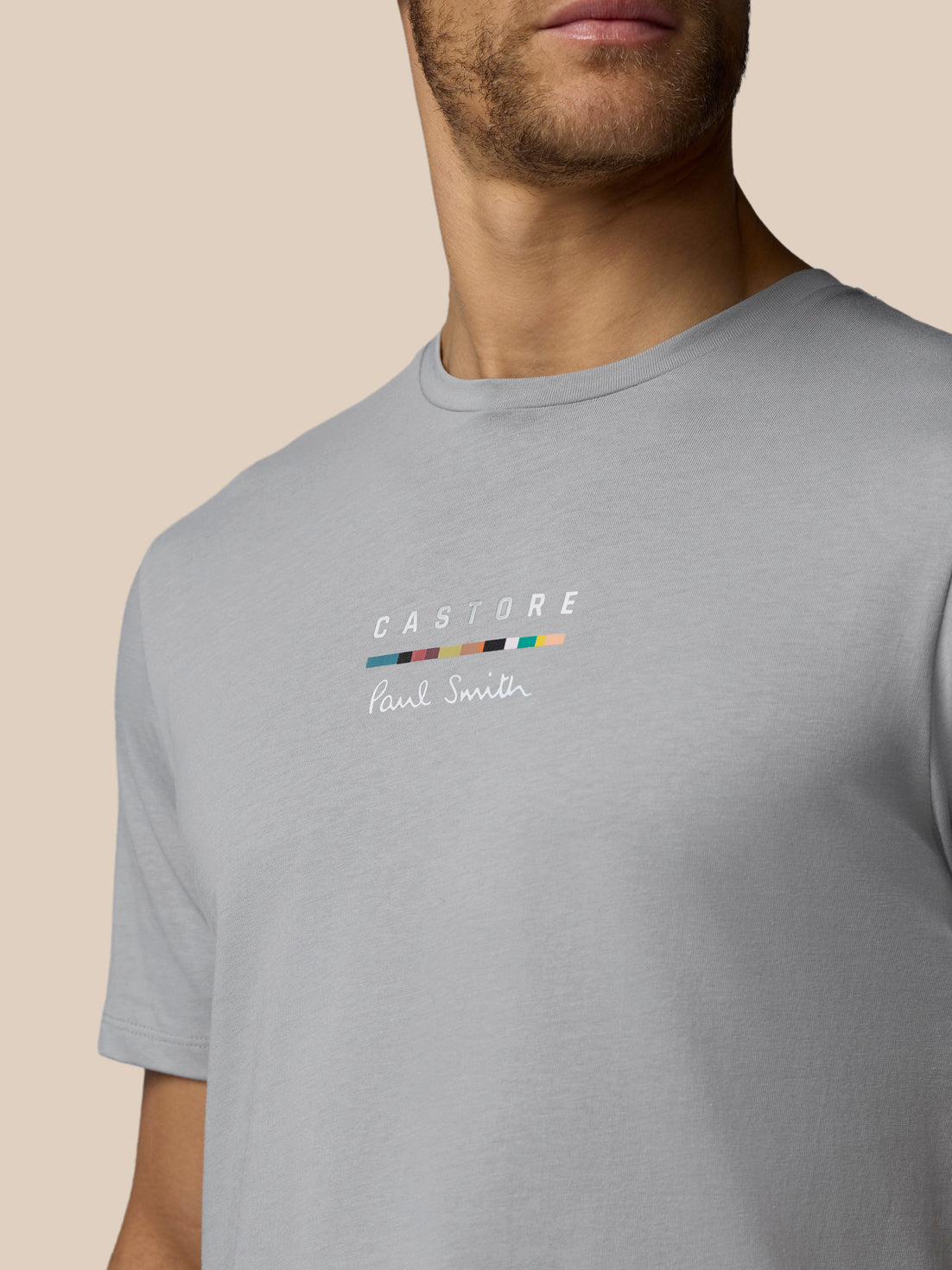 Gray t-shirt with a brand logo on a beige background