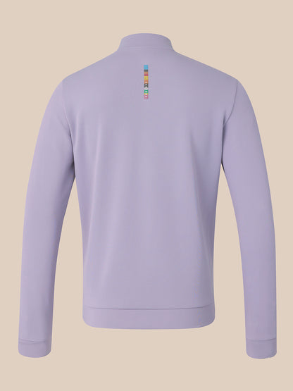 A light purple long-sleeve quarter-zip sweatshirt shown from the back, featuring a small colorful vertical logo on the upper back, set against a solid beige background.