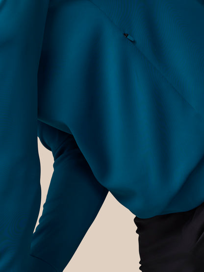 Close-up of a blue sweater with a beige background