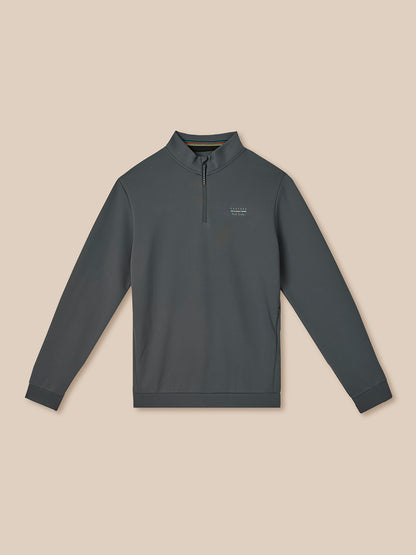 Dark gray long-sleeve pullover with a small logo on a beige background