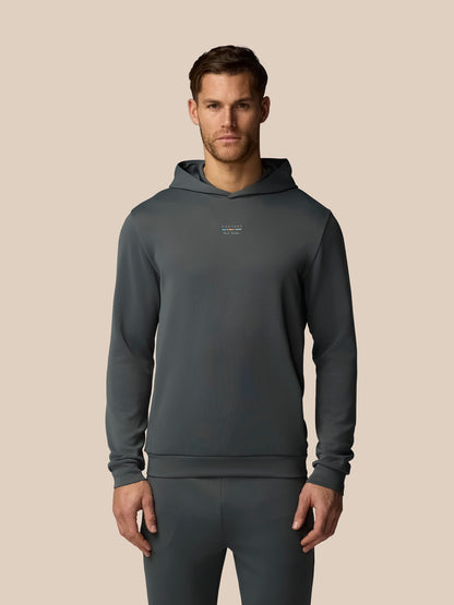 Man wearing a gray hoodie and pants on a beige background