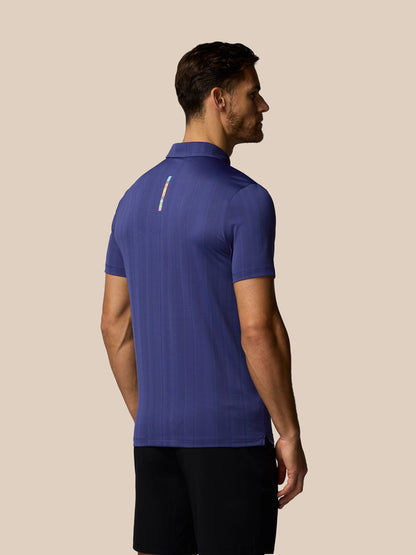 Man wearing a blue polo shirt on a beige background