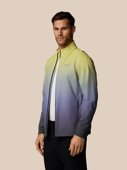 Man wearing a gradient jacket on a beige background