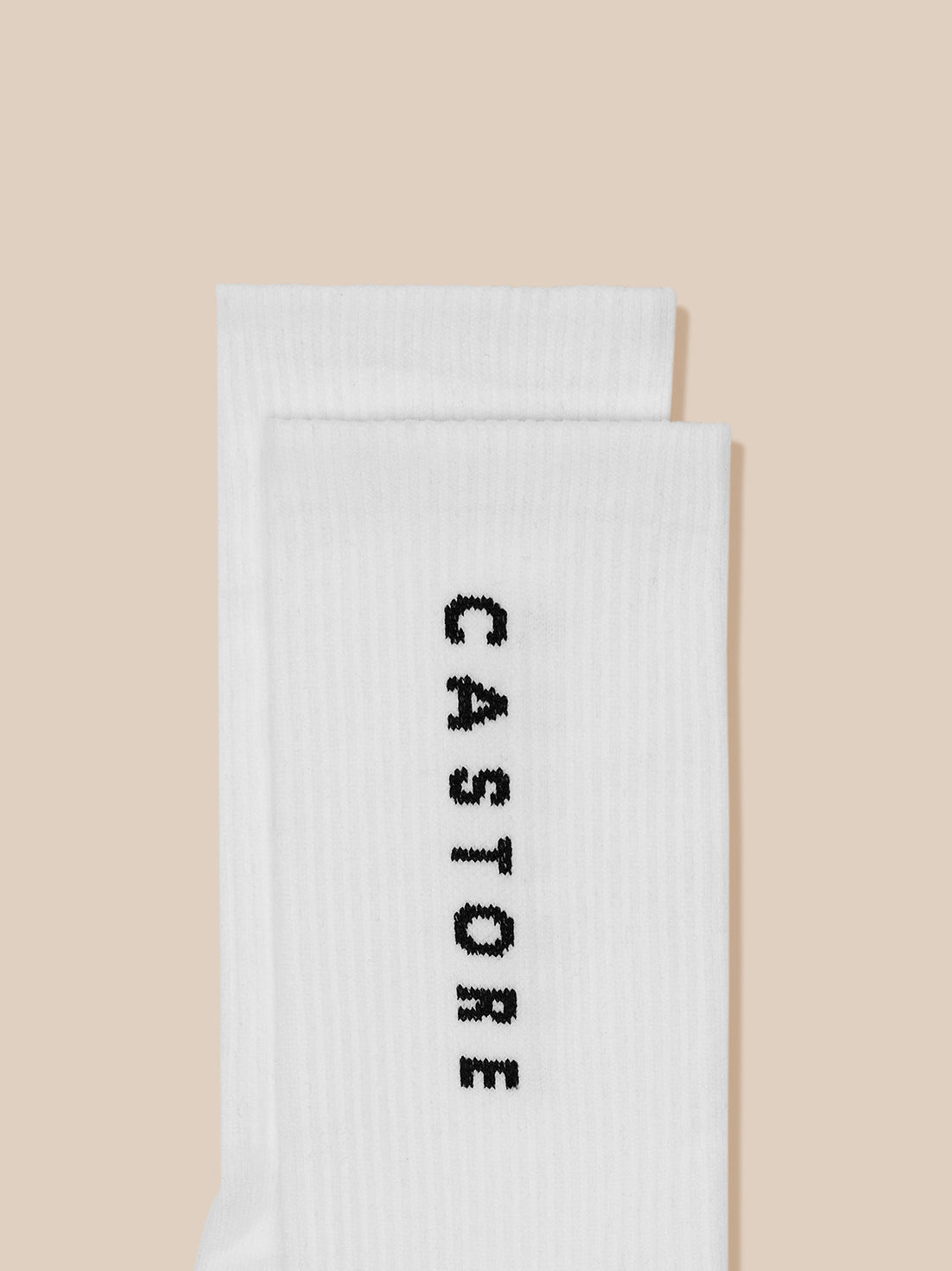 White sock featuring black CASTORE branding along the leg