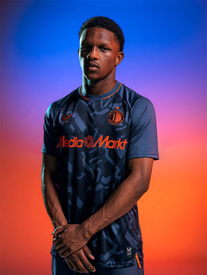 Male model wearing Feyenoord 2026-27 third pro shirt in navy with orange detailing and sponsor graphics