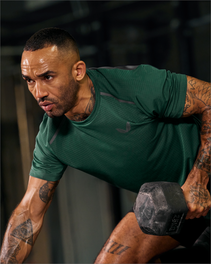 Back view of a man in green Apex Aeromesh T-Shirt with dark back panels and spine branding