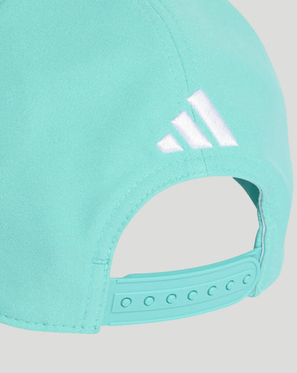 Close-up of a turquoise cap with Adidas logo on a light gray background