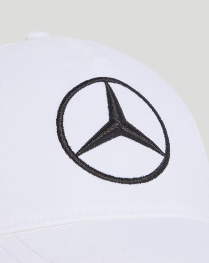 White cap with a black Mercedes emblem embroidered on the front panel.