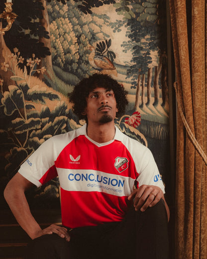 Model wearing FC Utrecht 24/25 Fourth Shirt featuring red and white design and crest on chest