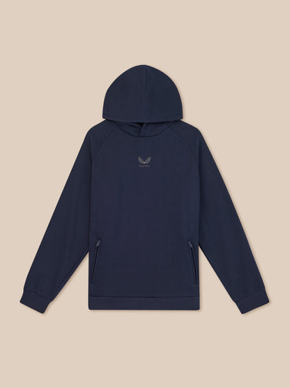 Navy blue hoodie with a small logo on a beige background
