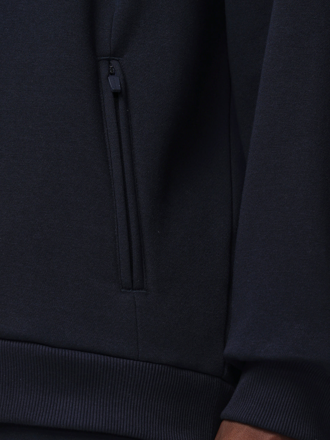 Close-up of a dark blue hoodie with a zipper detail.
