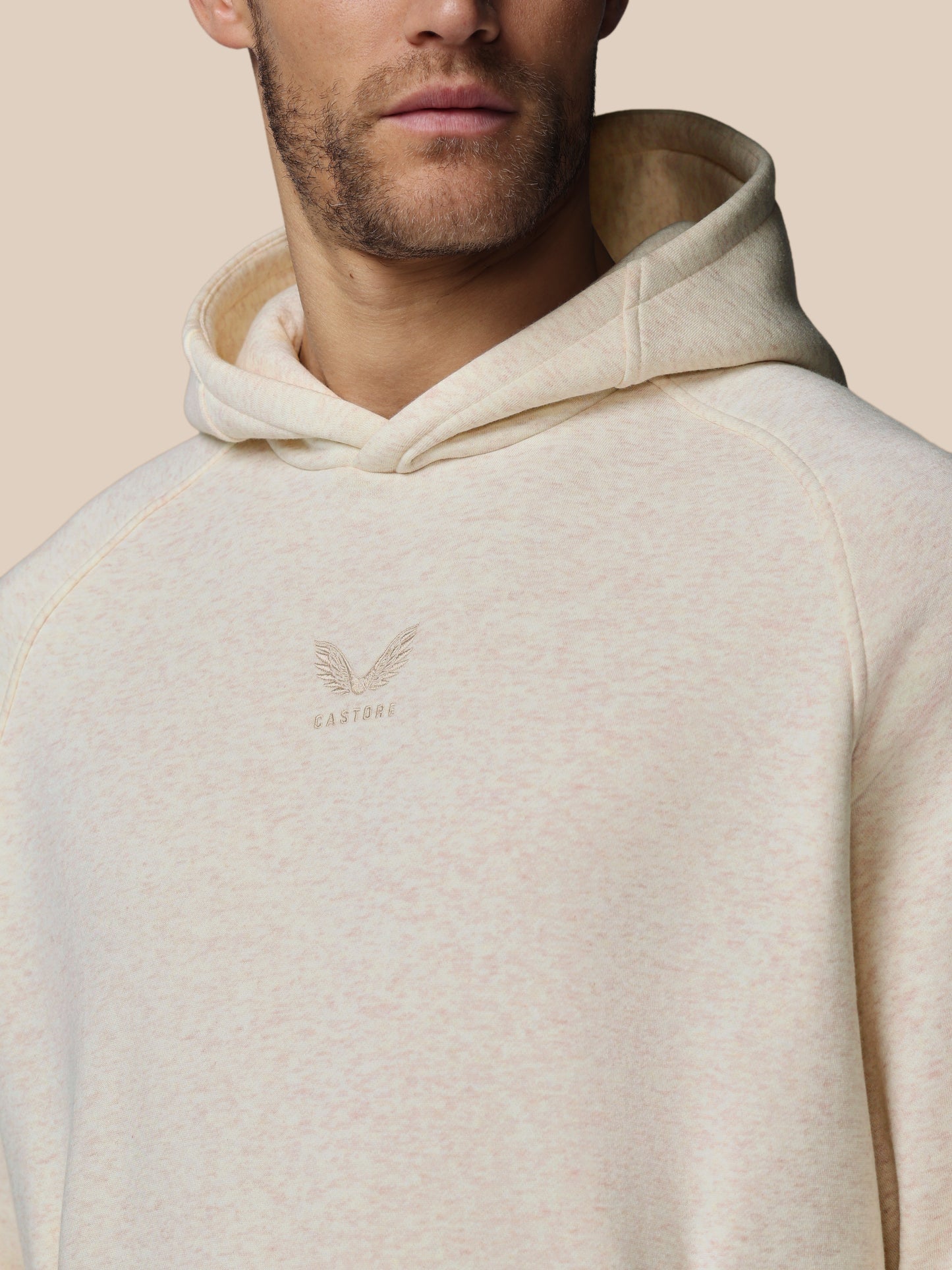 Beige hoodie with a brand logo on a beige background