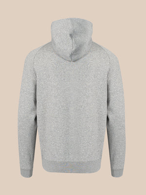 A light gray heathered hoodie shown from the back, featuring a simple stitched hood and ribbed cuffs and hem, set against a solid beige background.