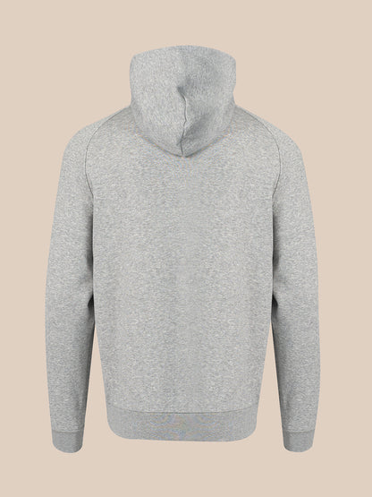 A light gray heathered hoodie shown from the back, featuring a simple stitched hood and ribbed cuffs and hem, set against a solid beige background.