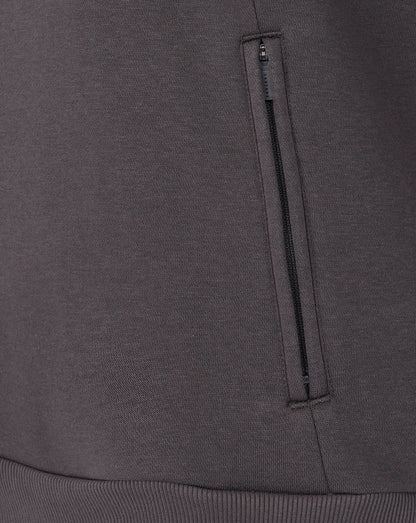 Close-up of a dark gray sweatshirt with a zipper pocket.