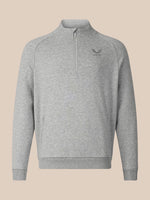 A light gray heathered quarter-zip sweatshirt with a small dark gray embroidered logo on the left chest, displayed on a solid beige background.