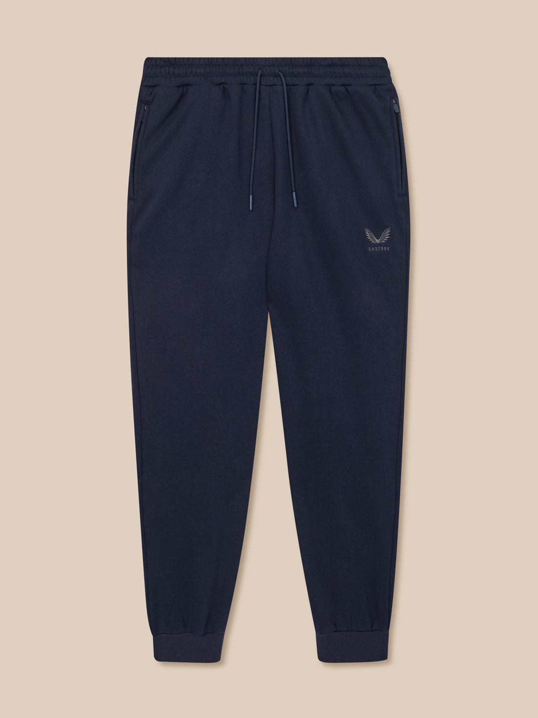 Navy blue jogger pants with a logo on a beige background