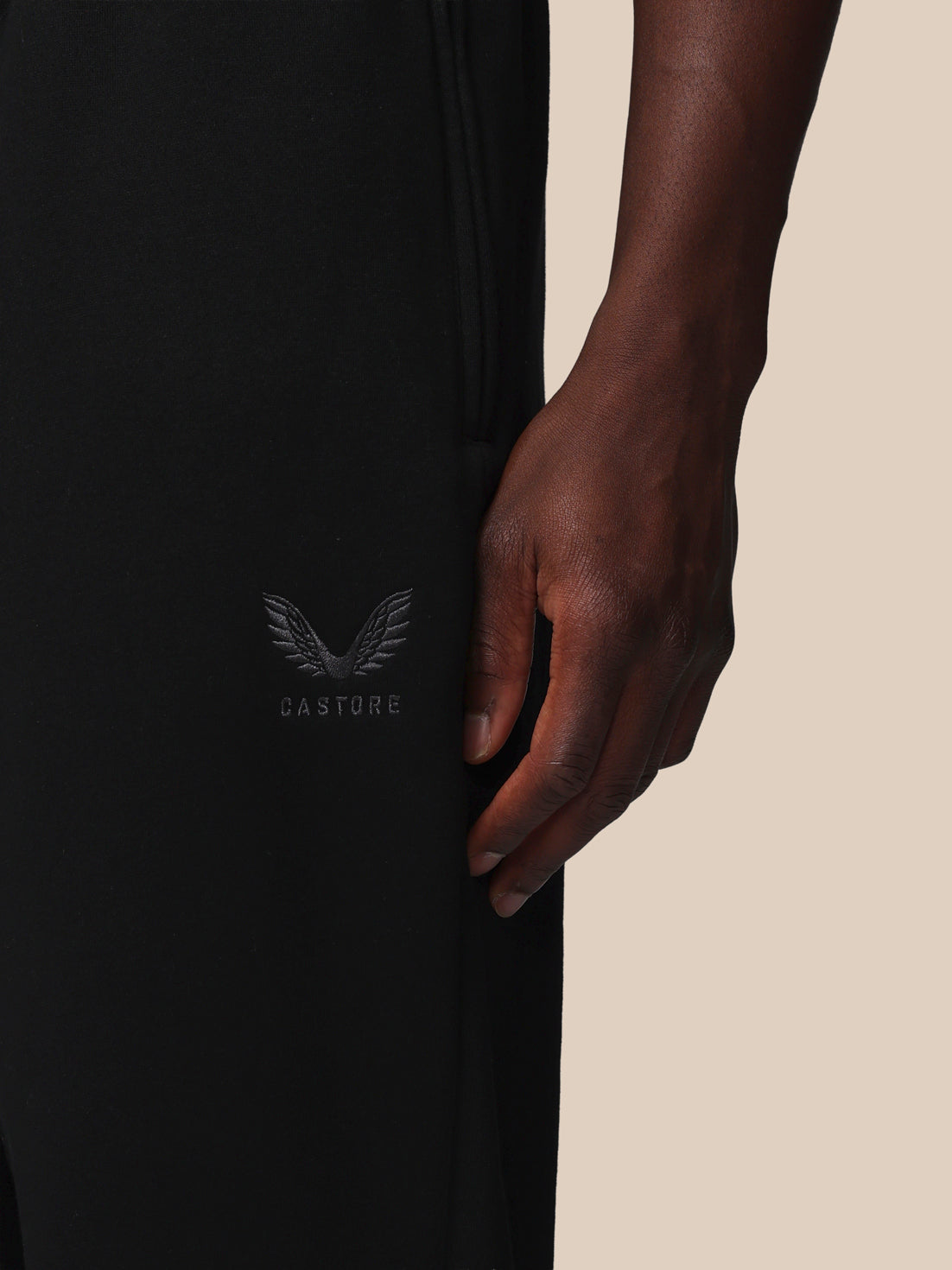 Black garment with a logo on a beige background