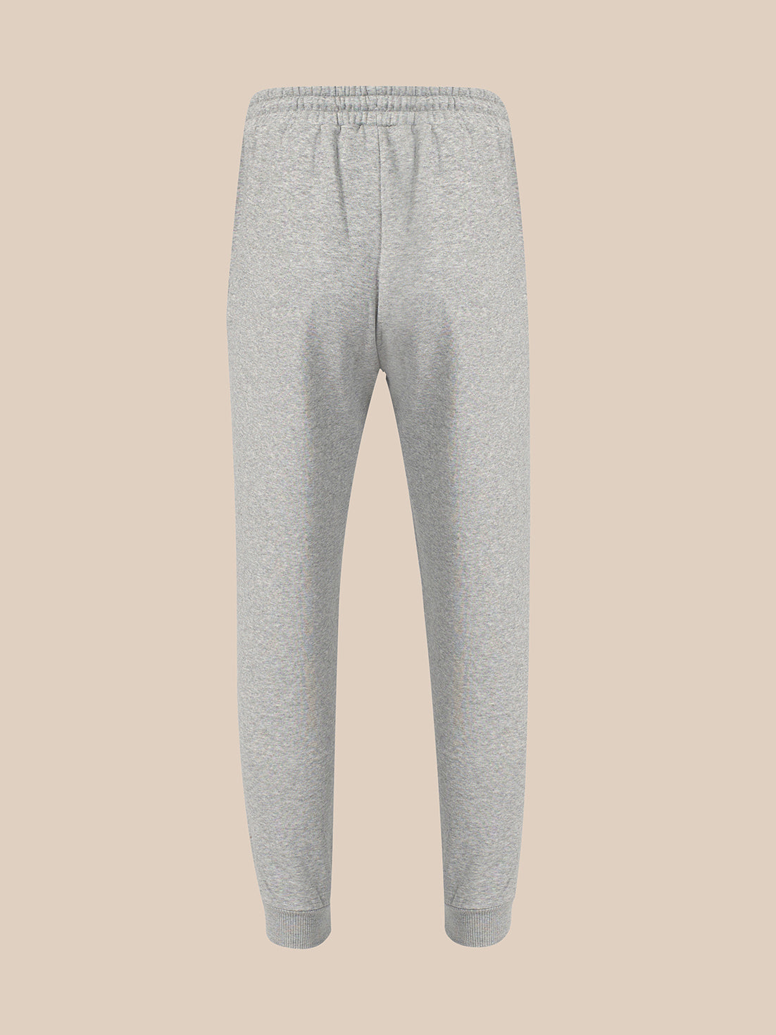 Light gray heather sweatpants with an elastic waistband and ribbed ankle cuffs, shown against a solid beige background.
