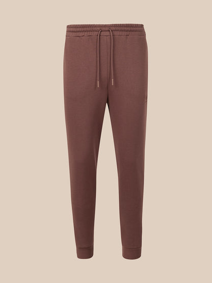 Deep mahogany pants on a light gray background