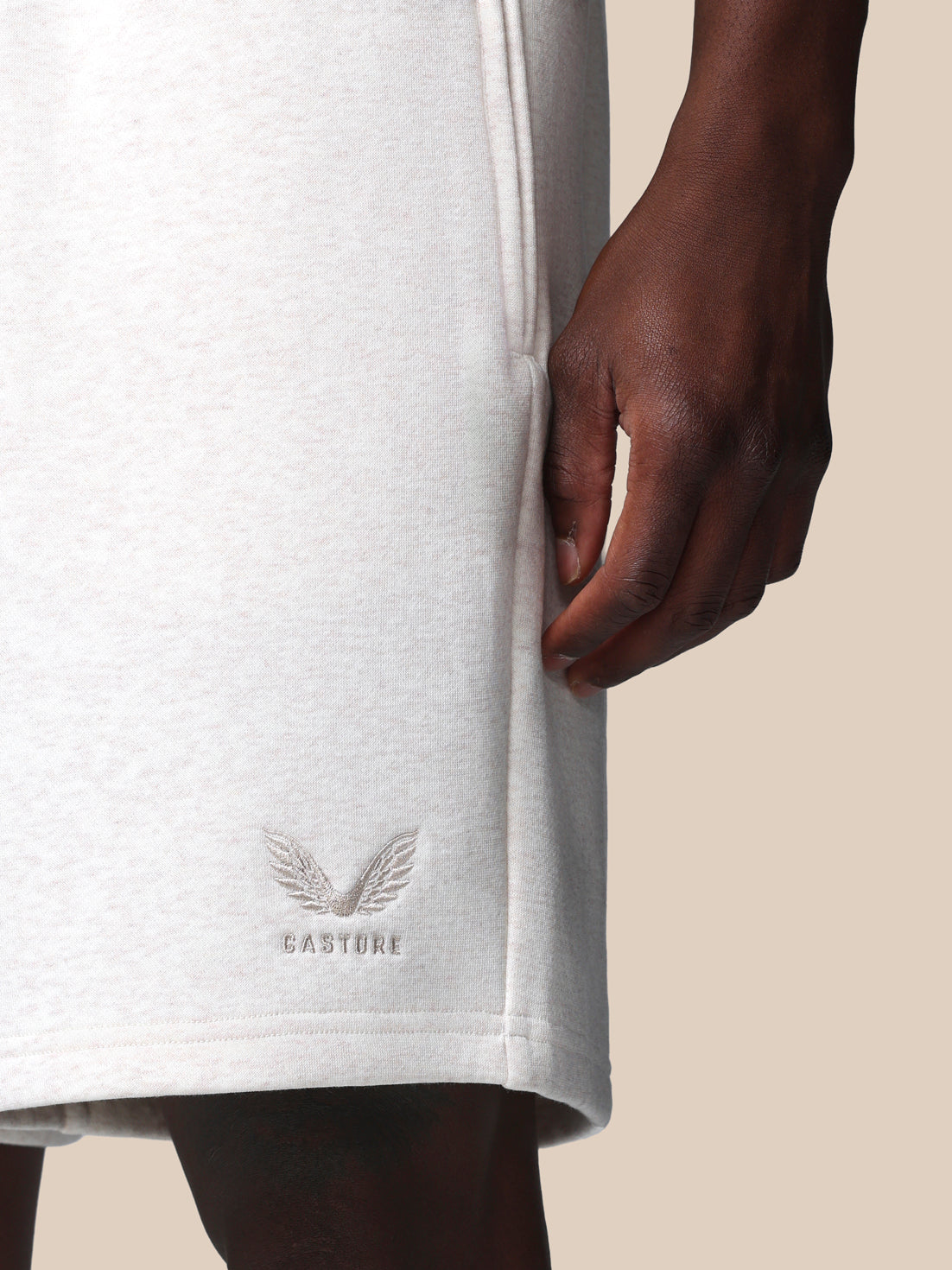 Close-up of a white t-shirt with a logo on a beige background