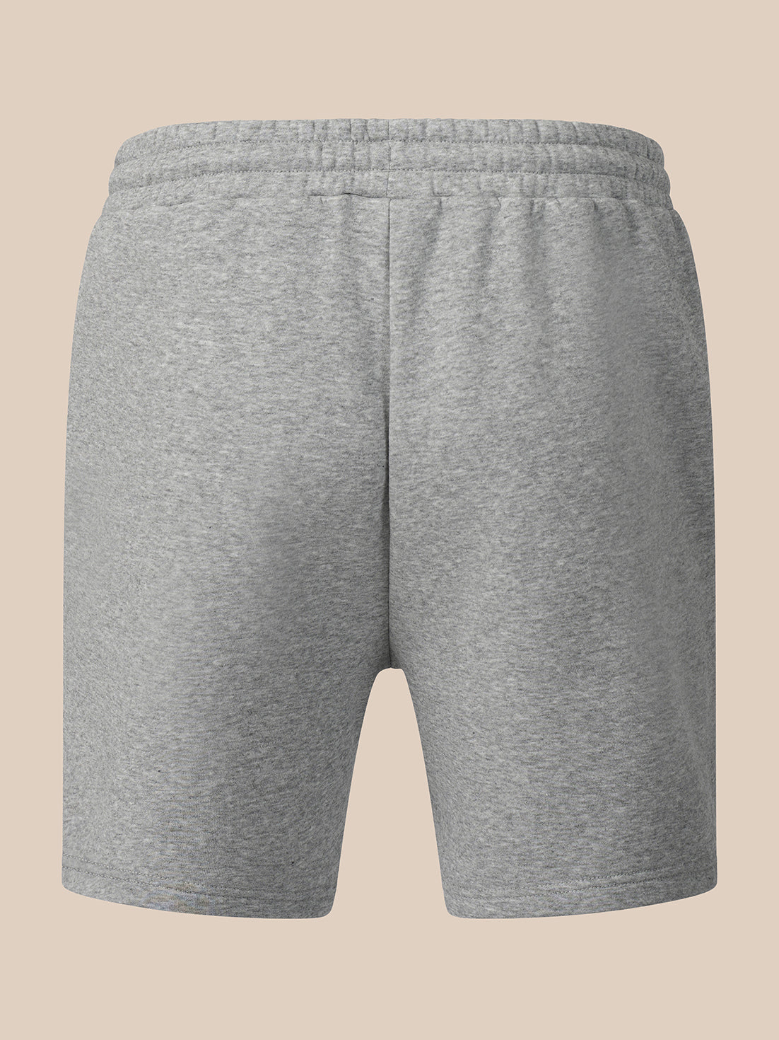 A pair of heather gray sweat shorts with an elastic waistband, shown from the back on a solid beige background.