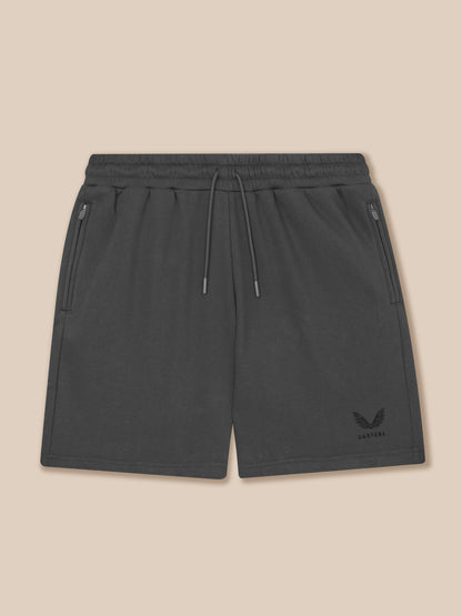 Dark gray shorts with a logo on a beige background