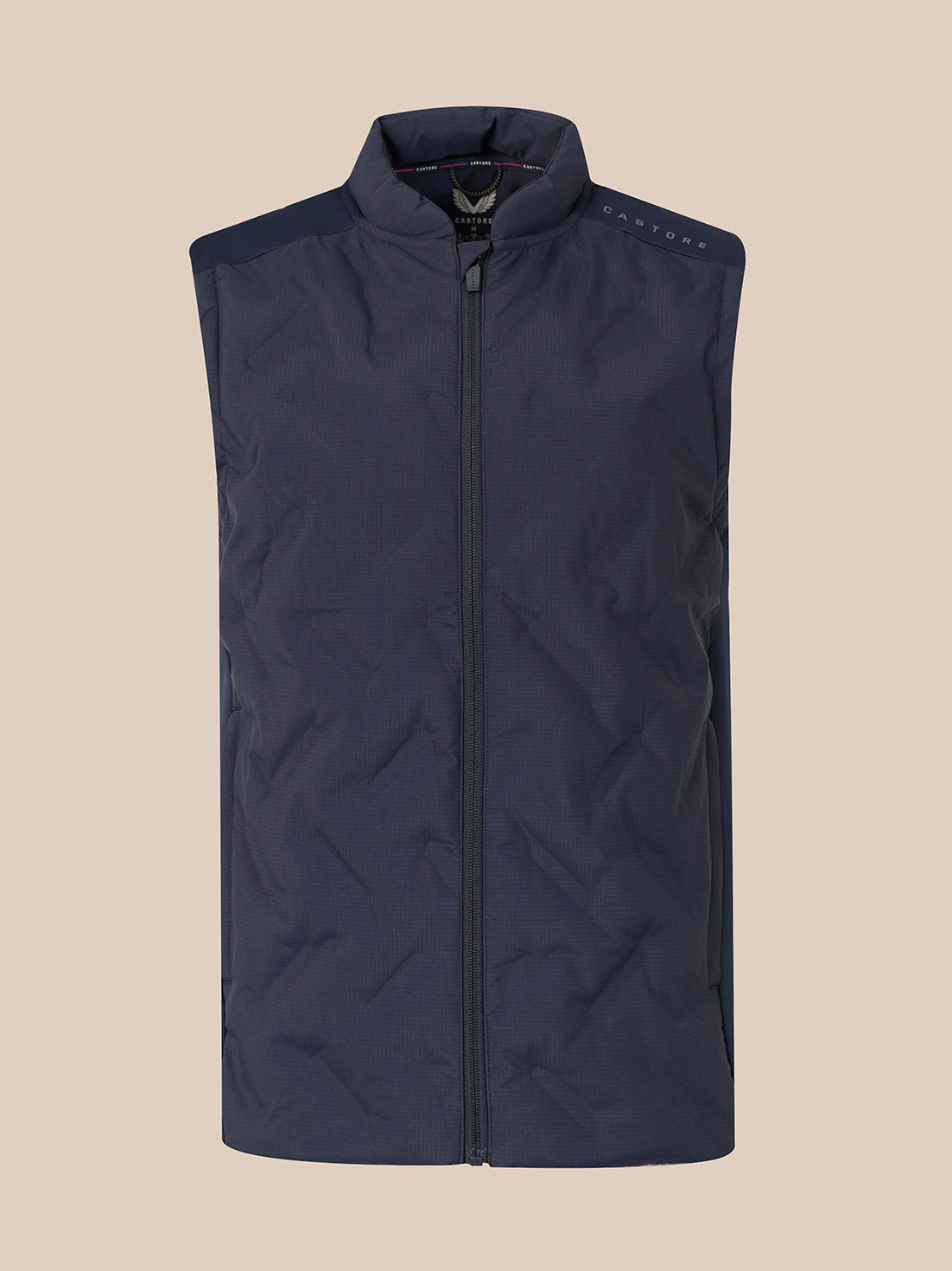 A sleeveless quilted puffer vest in dark navy blue, featuring a full-length front zipper, a stand-up collar, and subtle shoulder detailing, shown against a solid beige background.