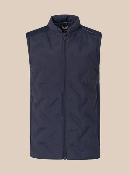 A sleeveless quilted puffer vest in dark navy blue, featuring a full-length front zipper, a stand-up collar, and subtle shoulder detailing, shown against a solid beige background.