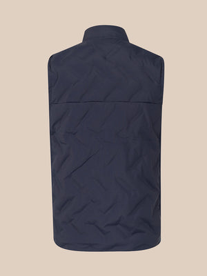 A sleeveless quilted vest in a dark navy blue, shown from the back against a solid beige background.