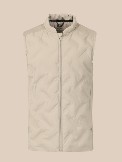 A sleeveless quilted puffer vest in a light cream or off-white color, featuring a full-length front zipper and a stand-up collar, shown against a solid beige background.