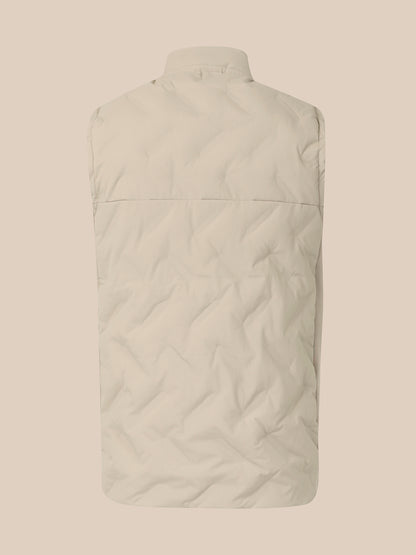 The back view of a light beige quilted puffer vest on a matching solid beige background.