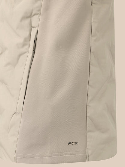 Close-up of a light beige technical jacket fabric with a vertical zip pocket and a small 'PROTEK' logo near the hem.