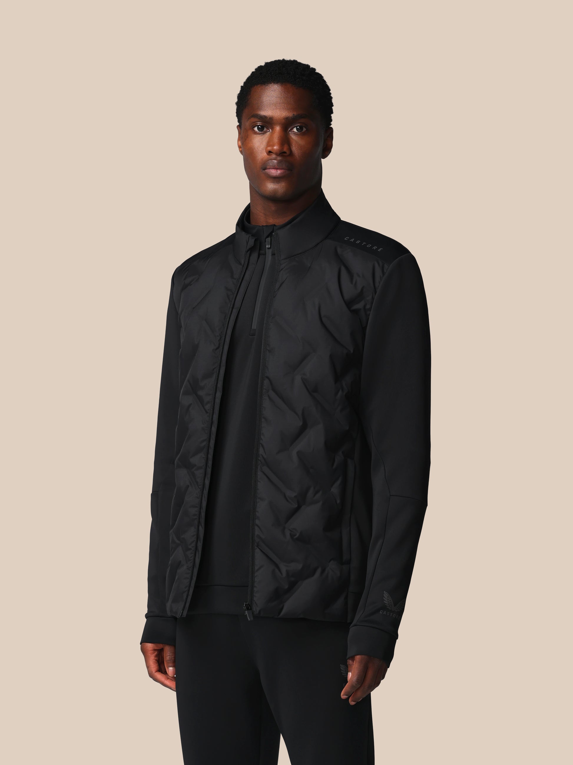 Man wearing a black jacket on a beige background