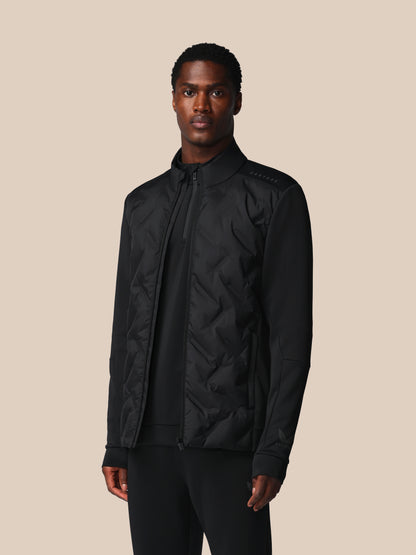 Man wearing a black jacket on a beige background