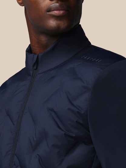 Navy blue jacket worn by a person on a beige background