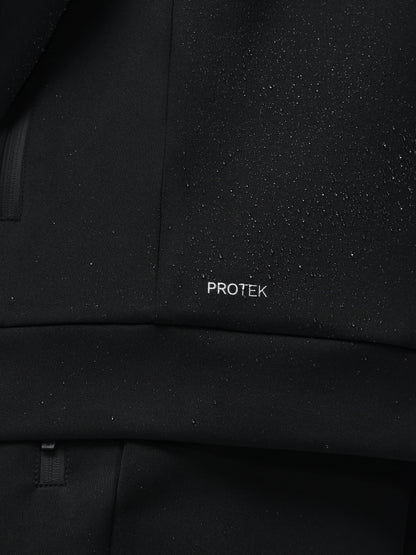 Close-up of a black textured fabric with 'PROTEK' branding.
