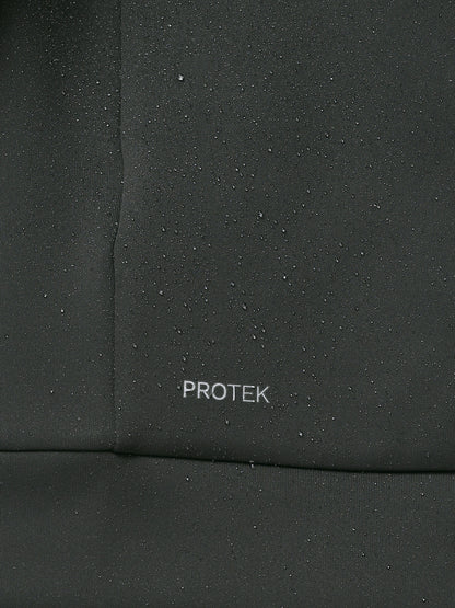 Close-up of a black fabric surface with 'PROTEK' branding.