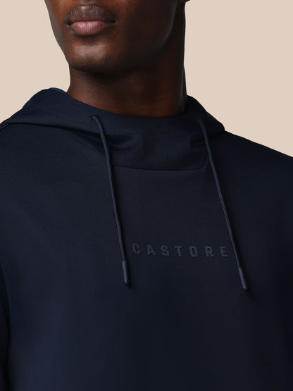 Navy hoodie with 'CASTORE' logo on a beige background