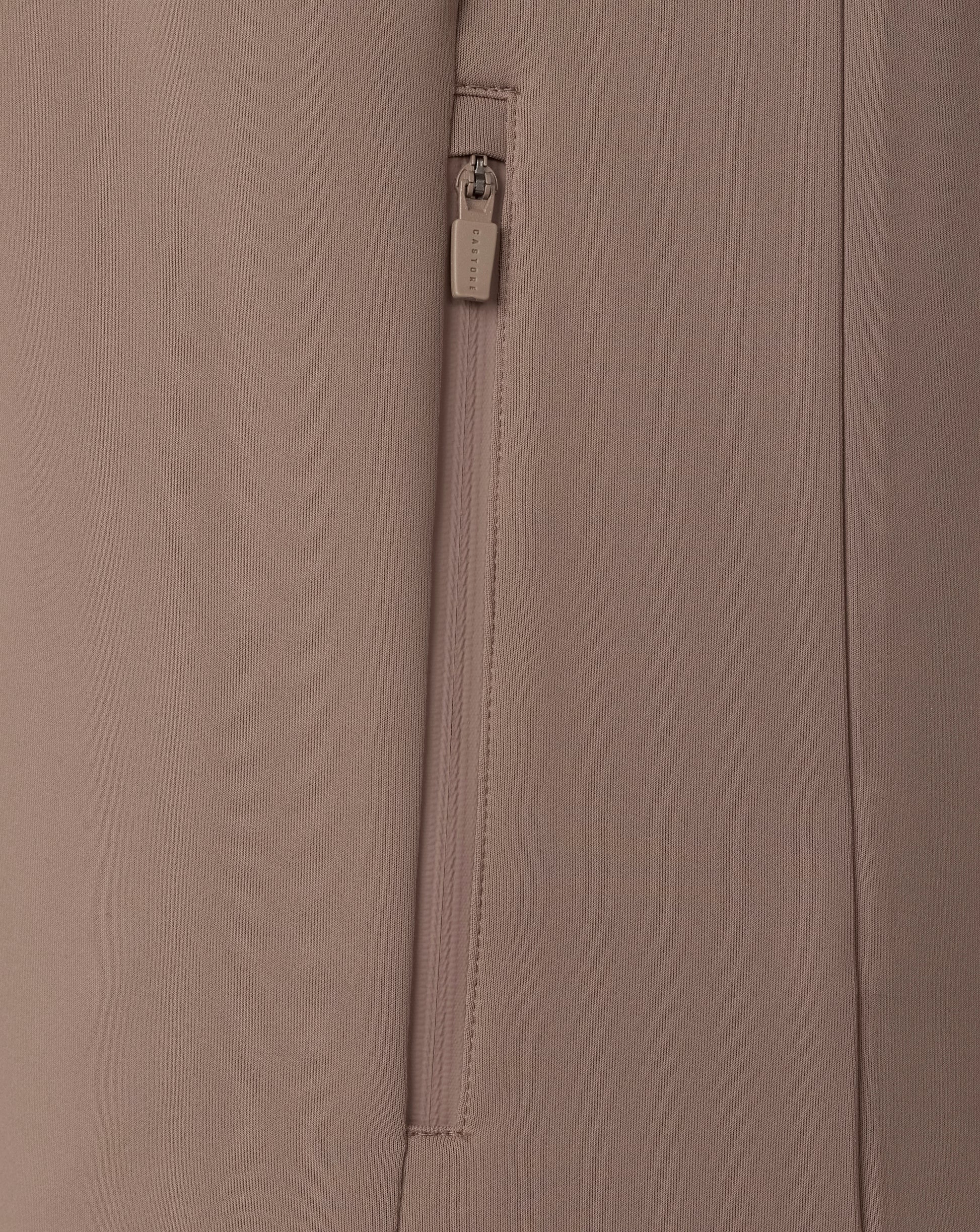 Close-up of a beige fabric with a zipper and brand label.