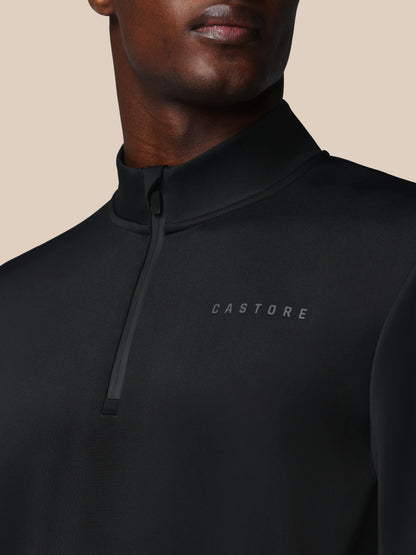 Black quarter-zip sweatshirt with 'CASTORE' logo on a beige background