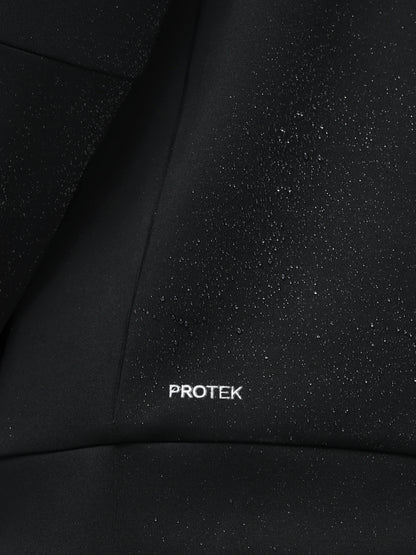 Close-up of black fabric with 'PROTEK' branding.