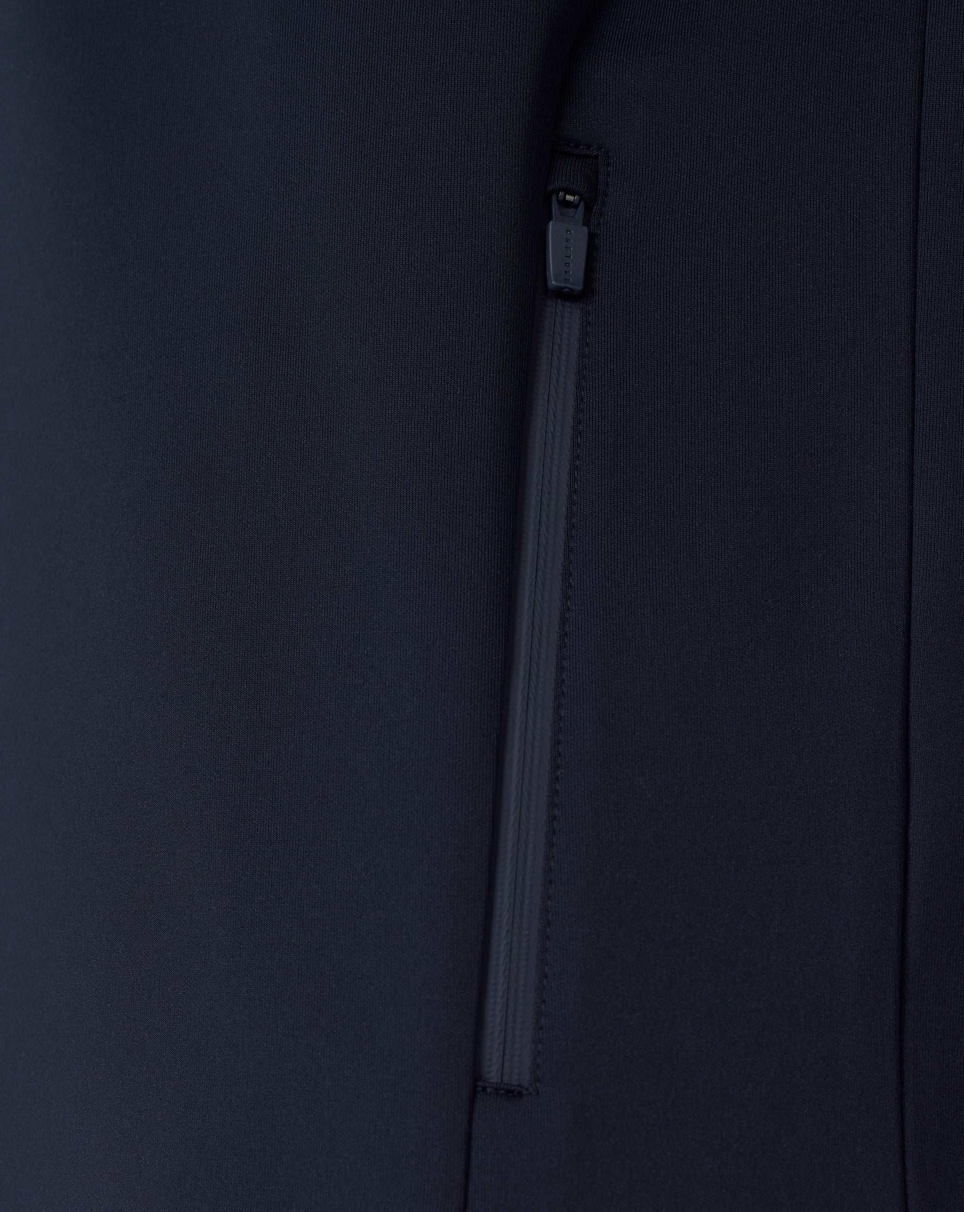 Close-up of a black jacket with a zipper on a dark background