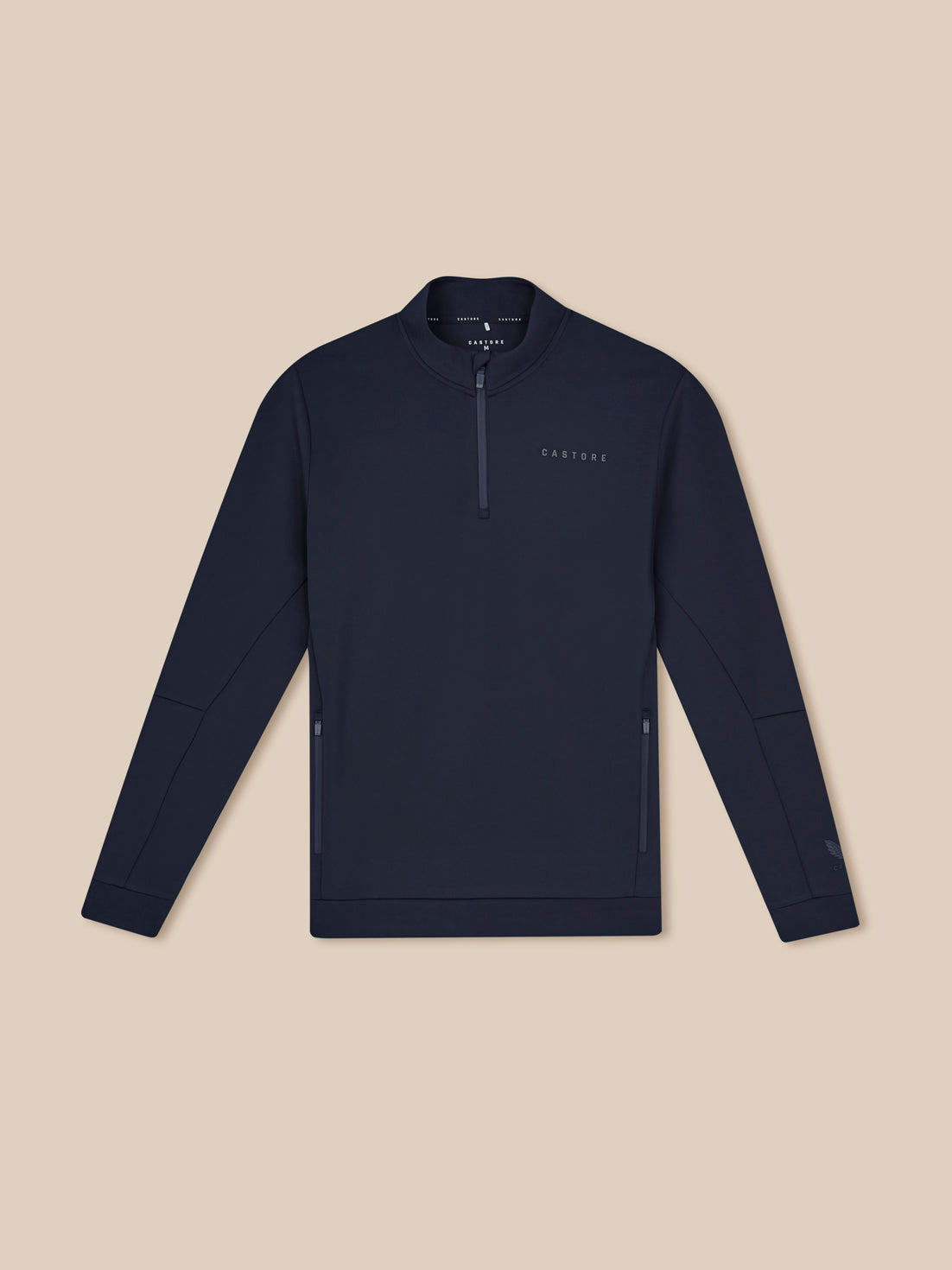 Navy blue pullover with a quarter zip on a beige background